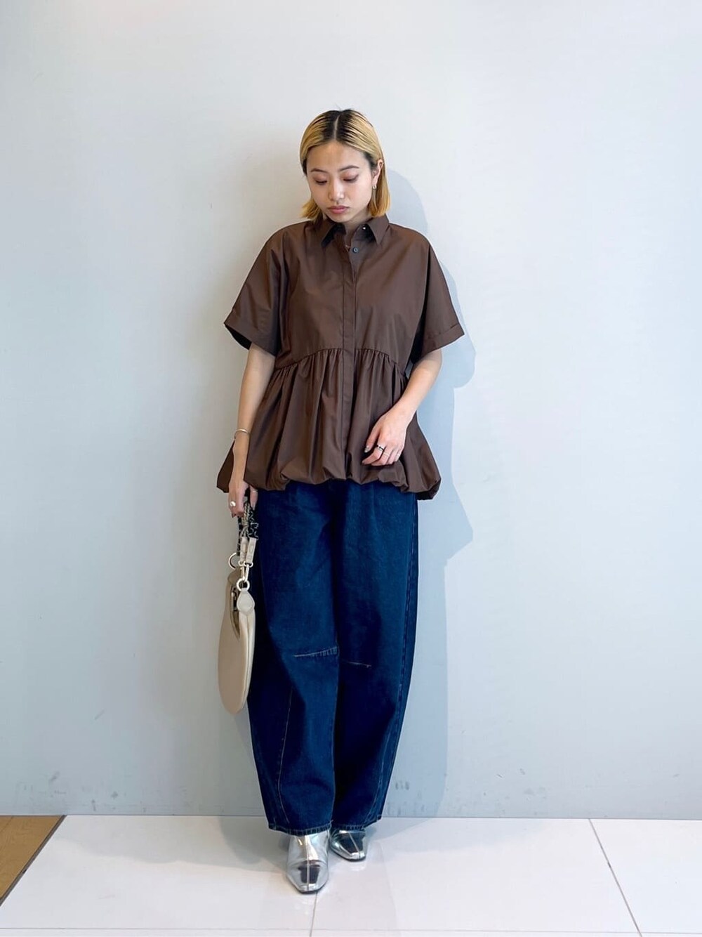 ブラウン系のシャツ/ブラウス、ブルー系のデニムパンツを着用したレディースの春コーディネートの8枚目の写真
