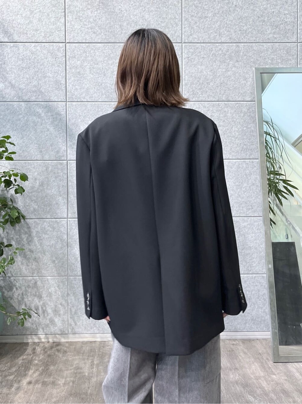 ブラック系のテーラードジャケット、グレー系のニット/セーター、グレー系のその他パンツを着用したレディースの秋コーディネートの8枚目の写真