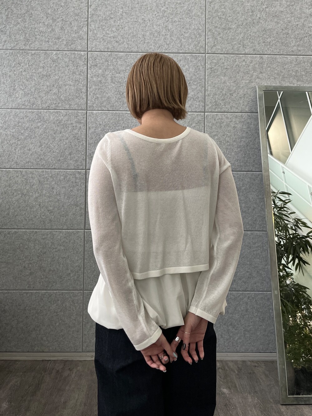 ブルー系のデニムパンツ、ホワイト系のアンサンブルを着用したレディースの春コーディネートの10枚目の写真