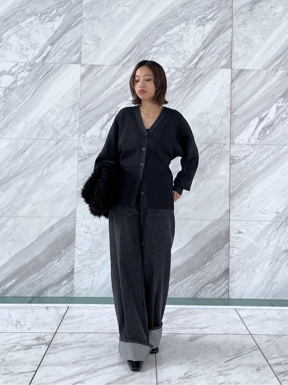 ブラック系のカーディガン/ボレロ、グレー系のデニムパンツ、ブラック系のトートバッグを着用したレディースの秋コーディネートの2枚目の写真