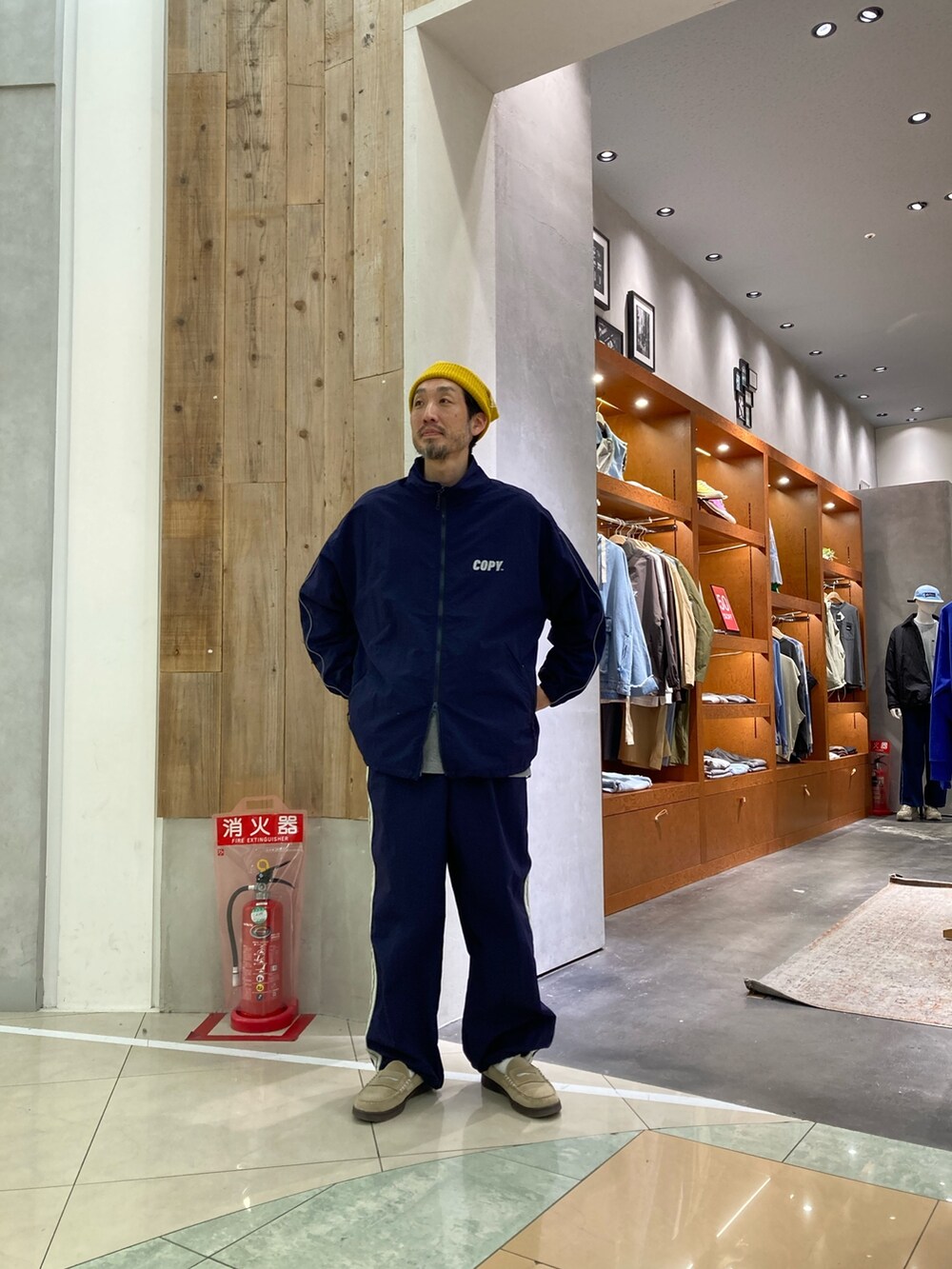 ブルー系のナイロンジャケット、ブルー系のその他パンツ、イエロー系のニットキャップ/ビーニーを着用したメンズの冬コーディネートの2枚目の写真