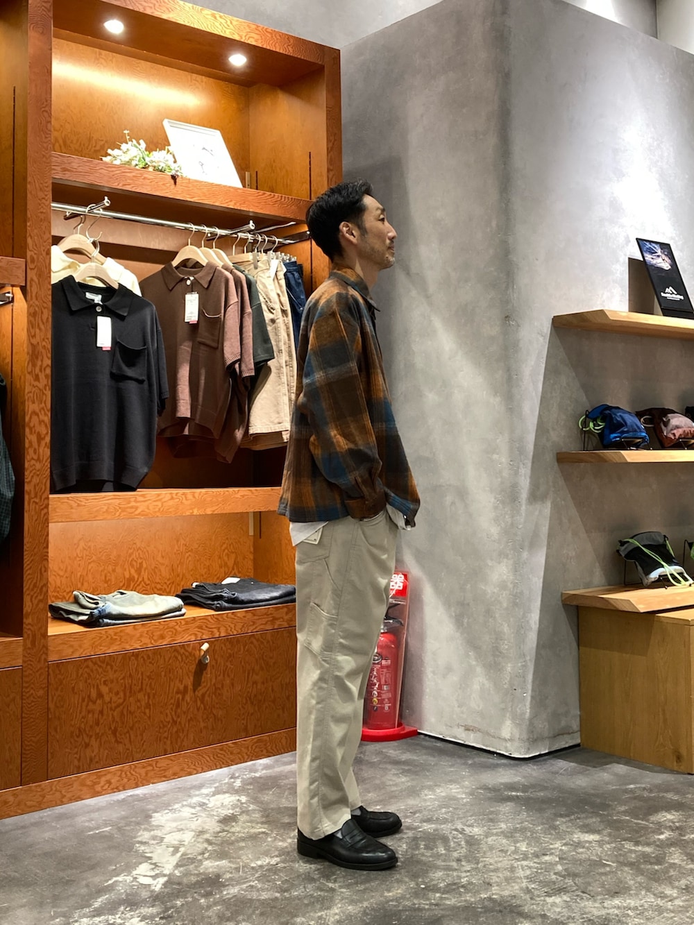 グレー系のデニムパンツ、オレンジ系のシャツ/ブラウスを着用したメンズの秋コーディネートの2枚目の写真