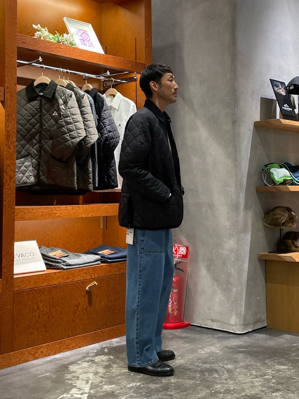 ホワイト系のニット/セーター、ブラック系のブルゾン、ブルー系のデニムパンツを着用したメンズの冬コーディネートの2枚目の写真