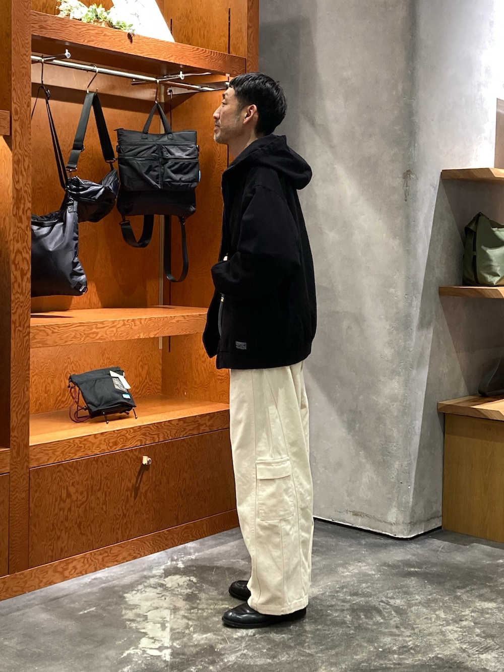 ブラック系のデニムジャケット、ブラック系のスウェット、ブラック系のカーゴパンツを着用したメンズの冬コーディネートの2枚目の写真