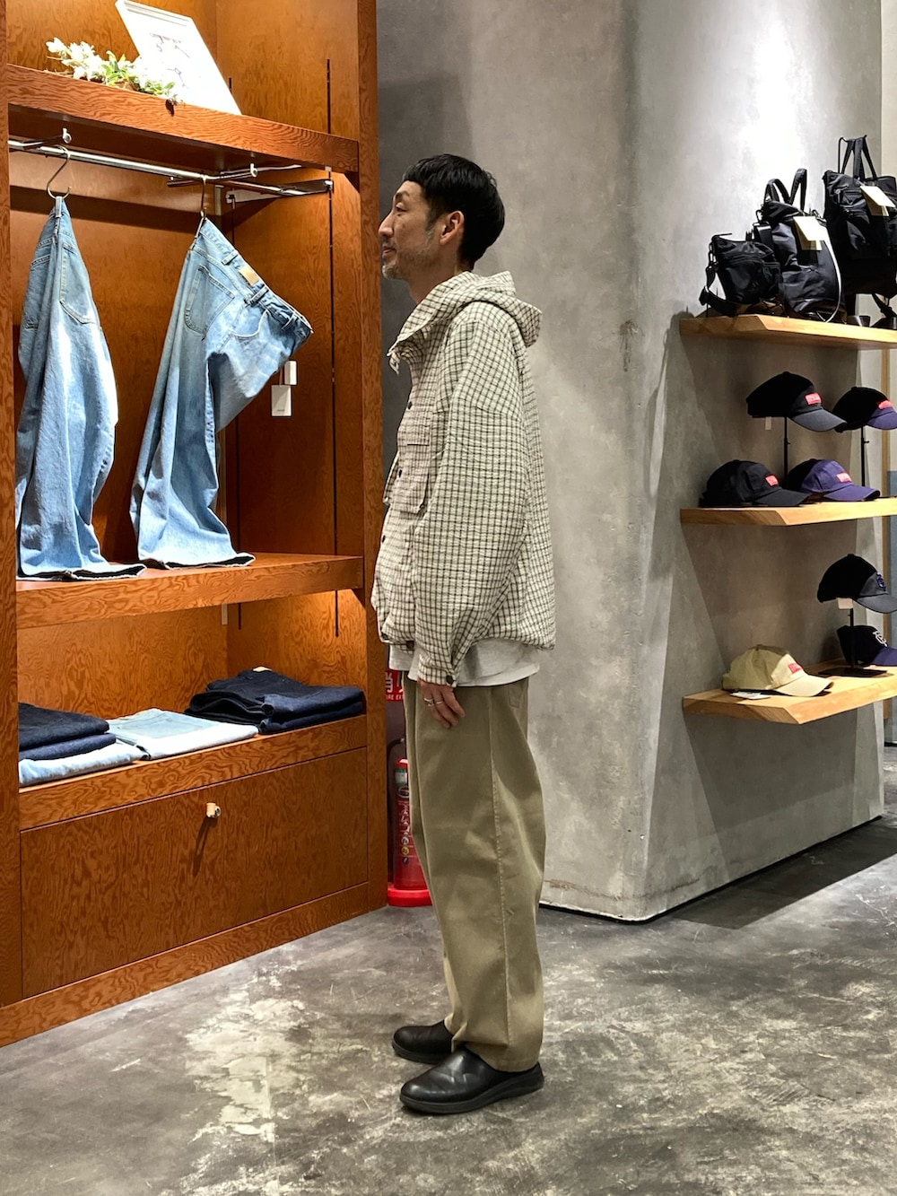 ホワイト系のパーカー、ベージュ系のチノパンツを着用したメンズの春コーディネートの2枚目の写真