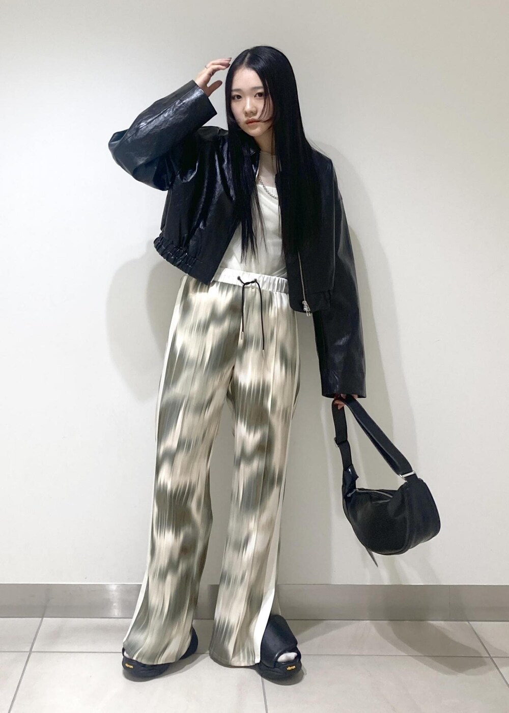 ベージュ系のその他パンツ、ブラック系のサンダル、ブラック系のブルゾンを着用したレディースの春コーディネートの3枚目の写真