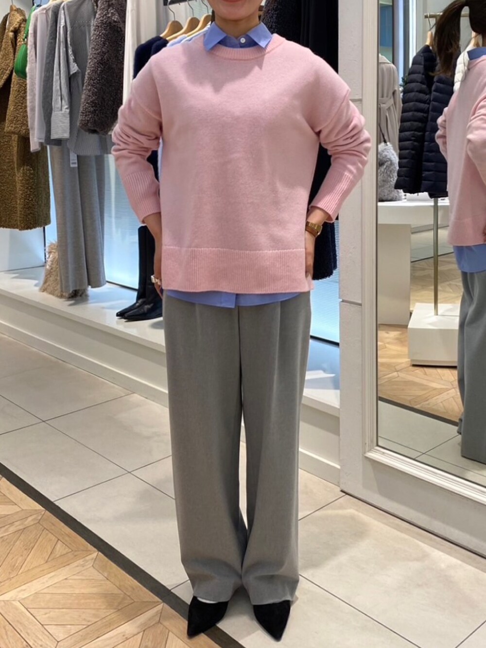 ピンク系のニット/セーター、ブルー系のシャツ/ブラウス、グレー系のその他パンツを着用したレディースの秋コーディネートの3枚目の写真