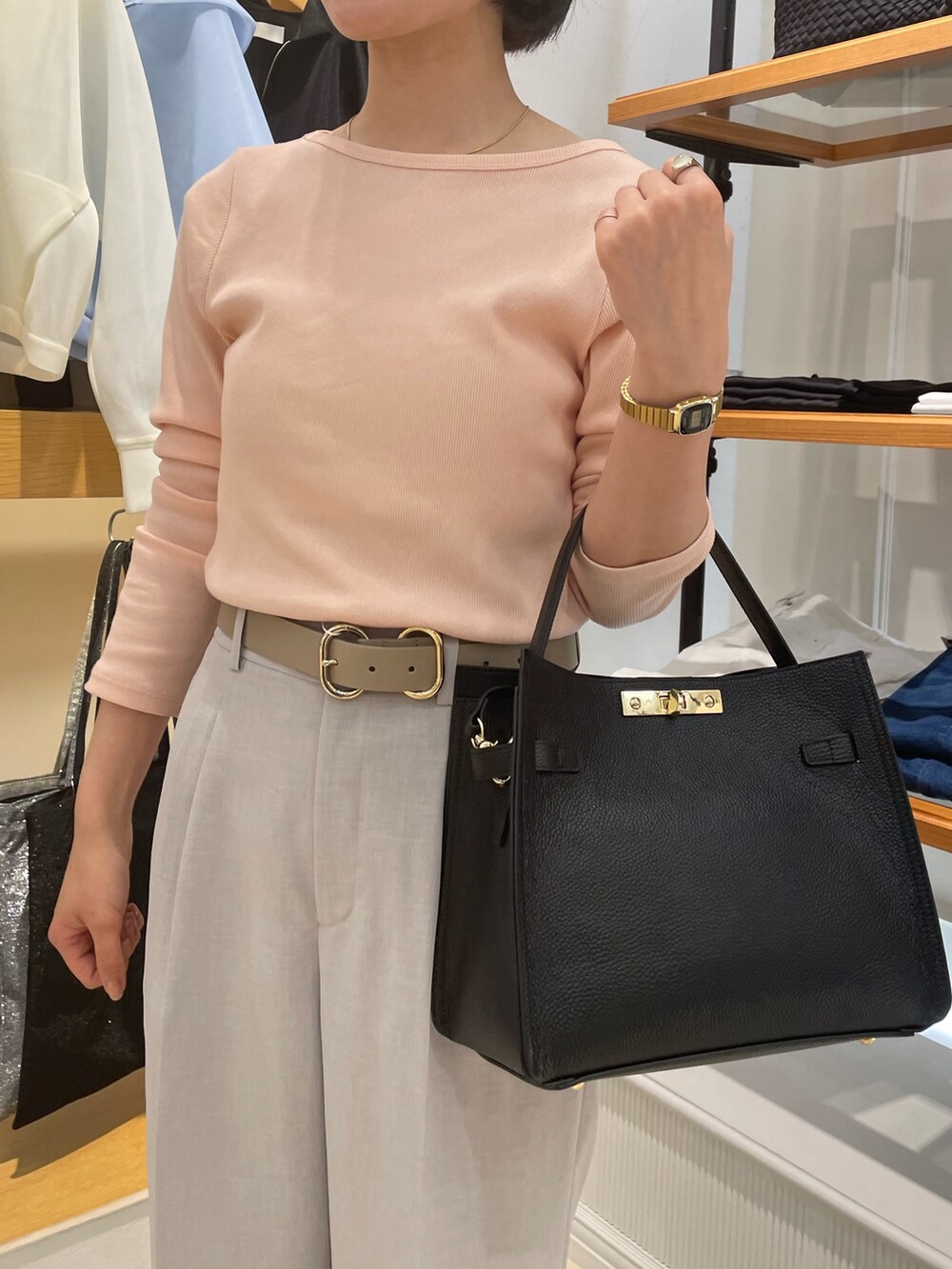 グレー系のその他パンツ、ピンク系のTシャツ/カットソー、ブラック系のショルダーバッグを着用したレディースの春コーディネートの4枚目の写真