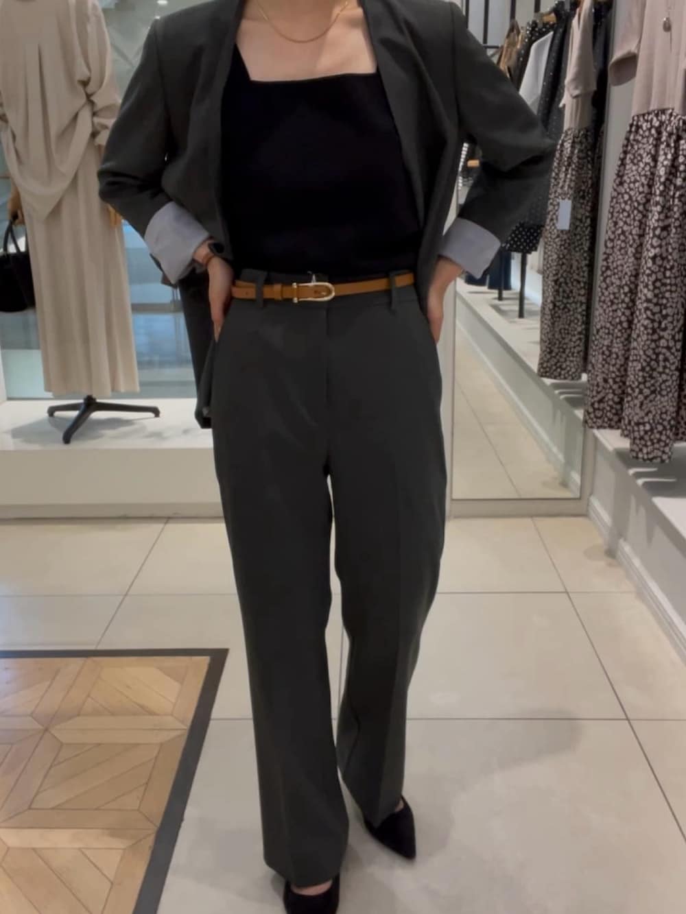 グレー系のノーカラージャケット、グレー系のその他パンツ、ブラック系のタンクトップを着用したレディースの秋コーディネートの4枚目の写真