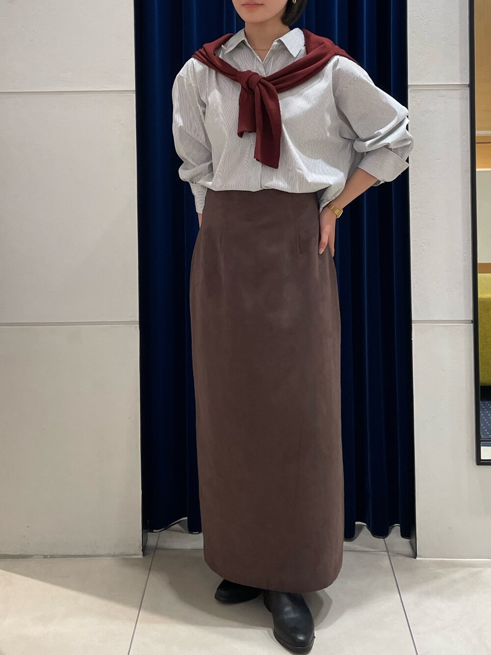 ホワイト系のシャツ/ブラウス、レッド系のカーディガン/ボレロ、ブラウン系のスカートを着用したレディースの秋コーディネートの5枚目の写真