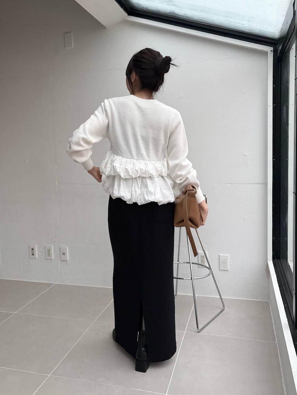 ホワイト系のニット/セーター、ブラック系のスカート、イエロー系のショルダーバッグを着用したレディースの秋コーディネートの2枚目の写真