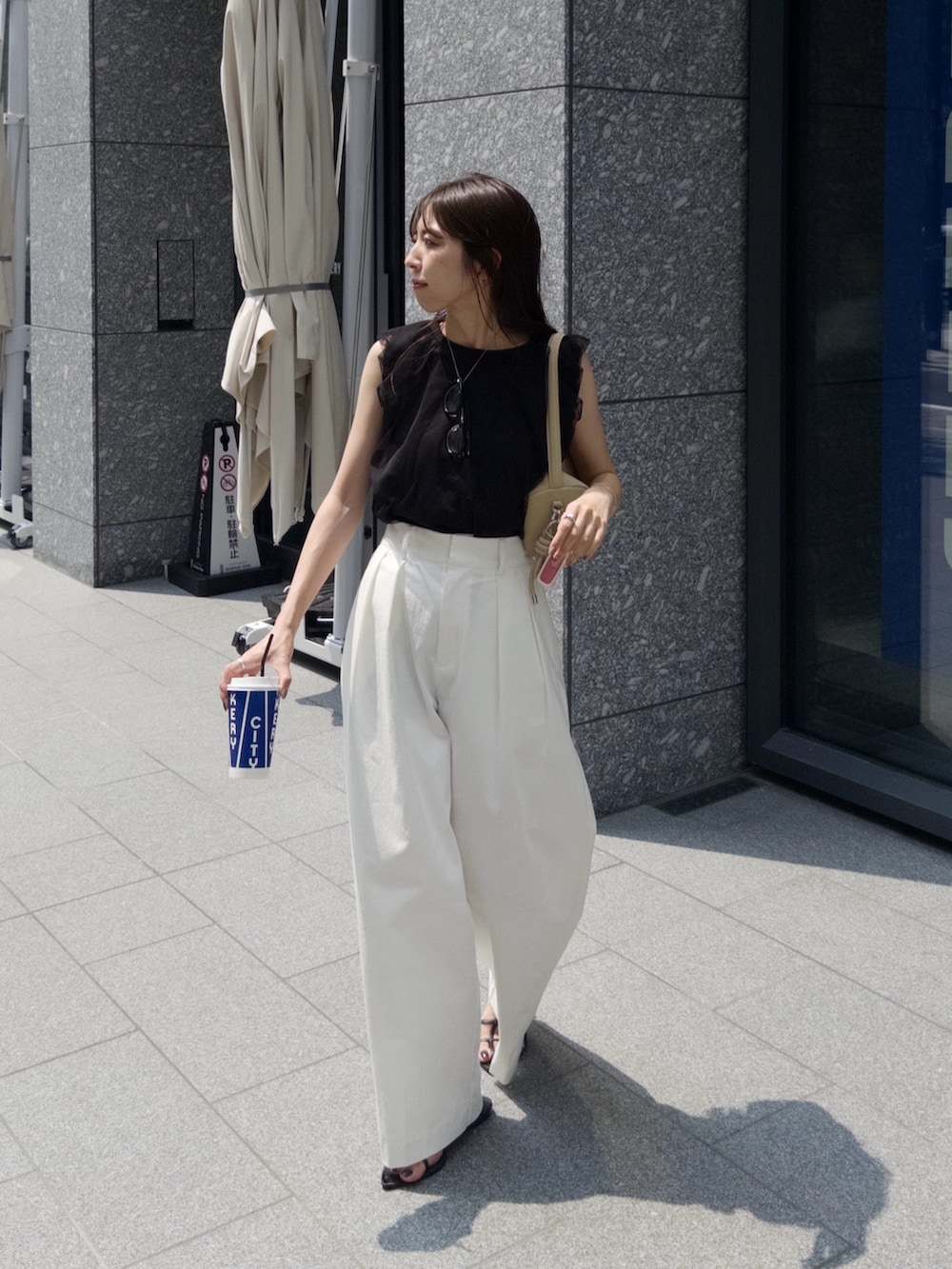 ベージュ系のショルダーバッグ、ブラック系のTシャツ/カットソー、ホワイト系のその他パンツを着用したレディースの夏コーディネートの2枚目の写真