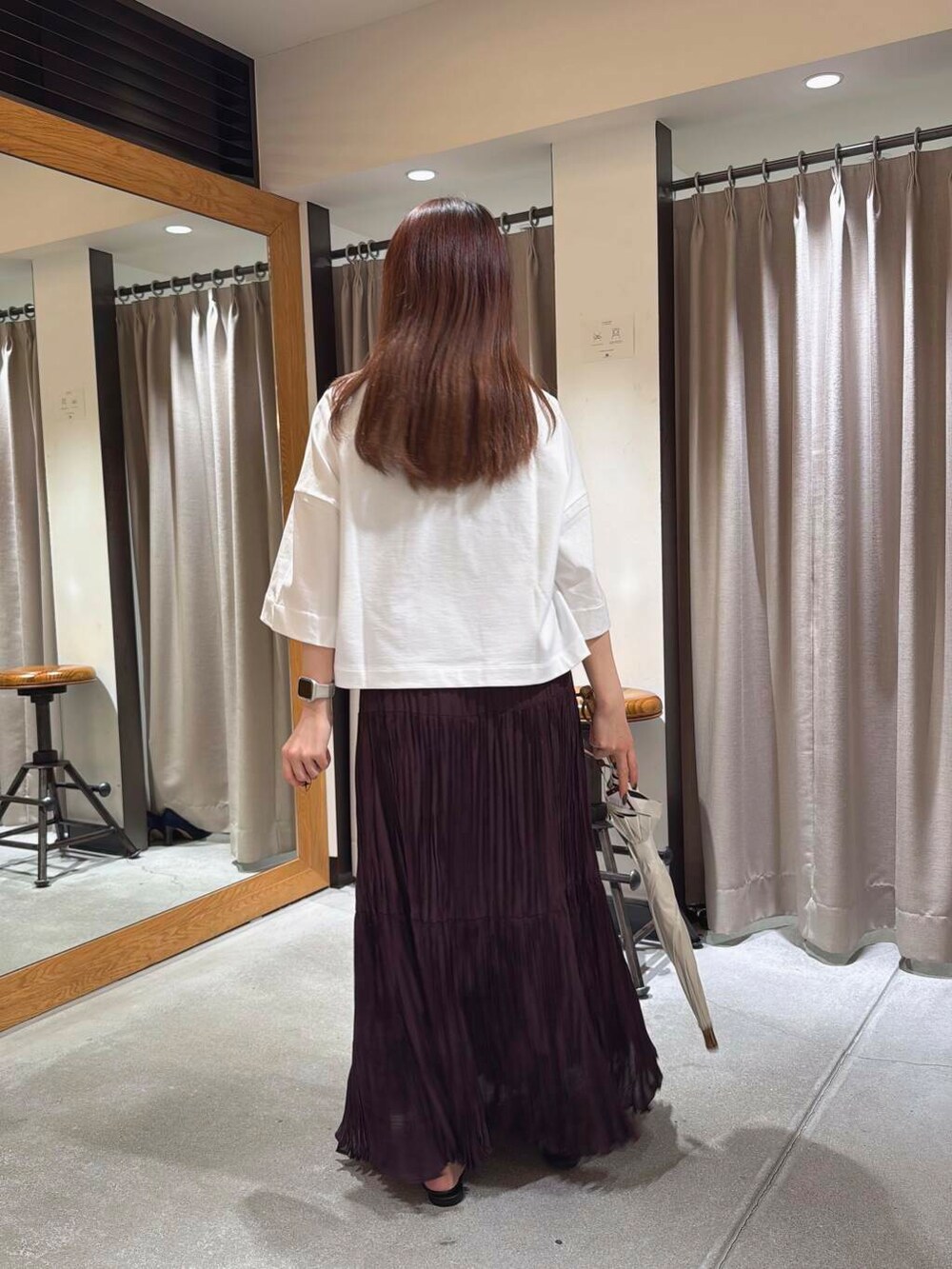 ホワイト系のTシャツ/カットソー、ブラウン系のスカート、ブラック系のサンダルを着用したレディースの春コーディネートの4枚目の写真