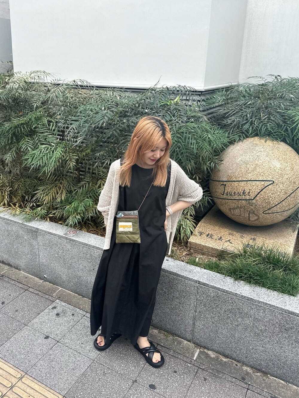 ブラック系のワンピース、ホワイト系のカーディガン/ボレロを着用したレディースの夏コーディネートの2枚目の写真