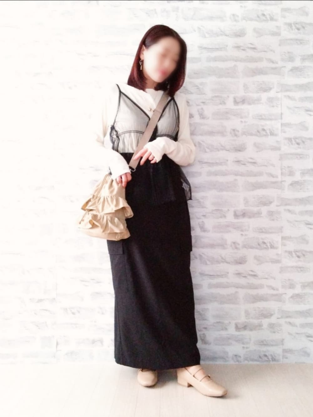 ブラック系のTシャツ/カットソー、ブラック系のスカート、ベージュ系のショルダーバッグを着用したレディースの春コーディネートの2枚目の写真
