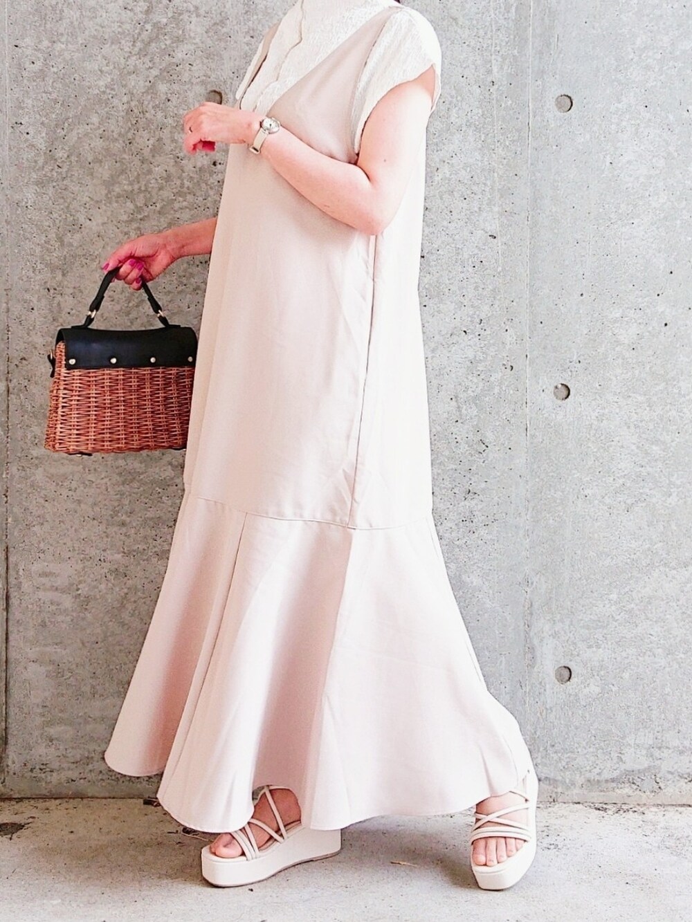 ホワイト系のトップス、ベージュ系のジャンパースカート、ブラウン系のバッグを着用したレディースの夏コーディネートの2枚目の写真