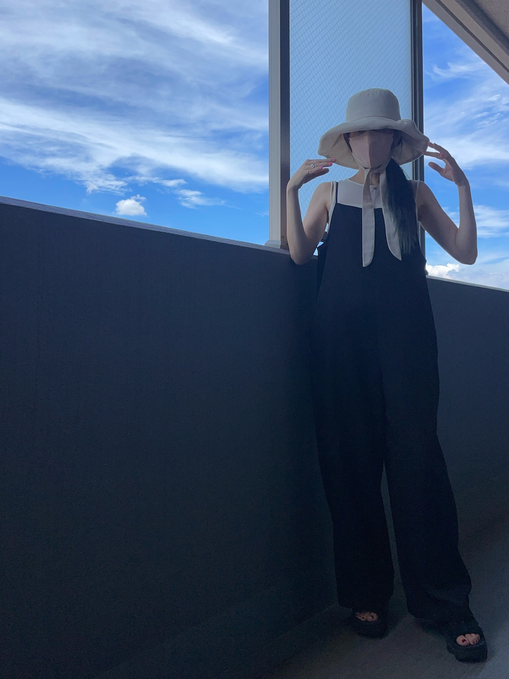 ホワイト系のハットを着用したレディースの夏コーディネートの2枚目の写真