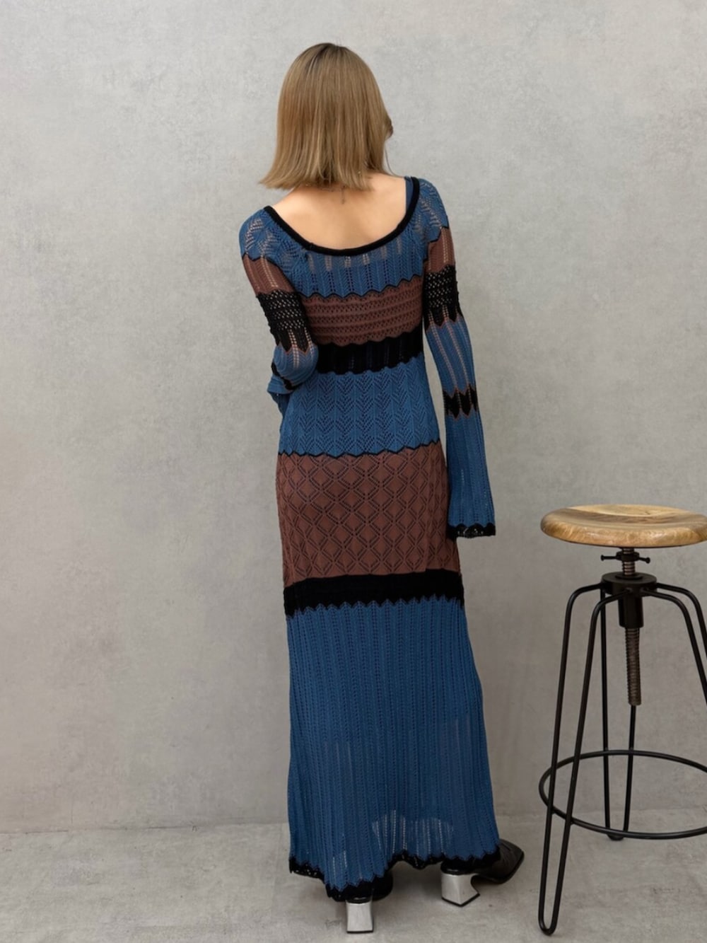 ブルー系のワンピース、ブラック系のパンプスを着用したレディースの春コーディネートの2枚目の写真