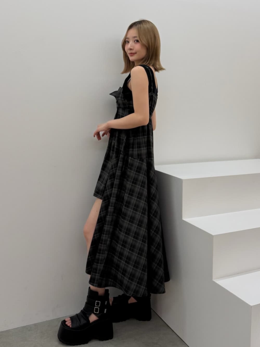 ブラック系のブーツ、ブラック系のワンピースを着用したレディースの春コーディネートの3枚目の写真