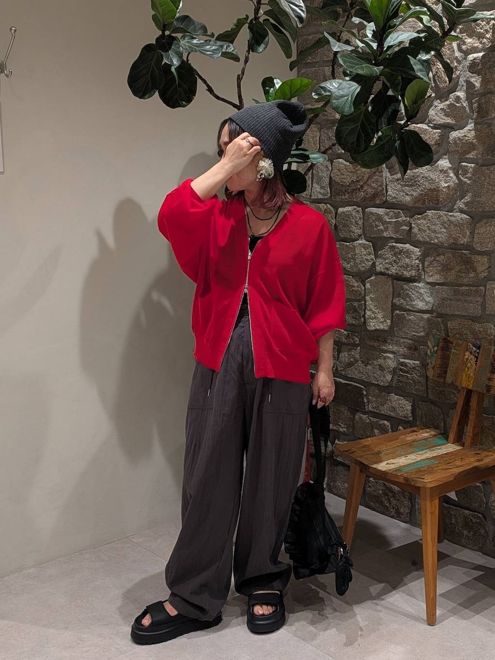 レッド系のカーディガン/ボレロ、ブラック系のサンダル、グレー系のその他パンツを着用したレディースの春コーディネートの2枚目の写真