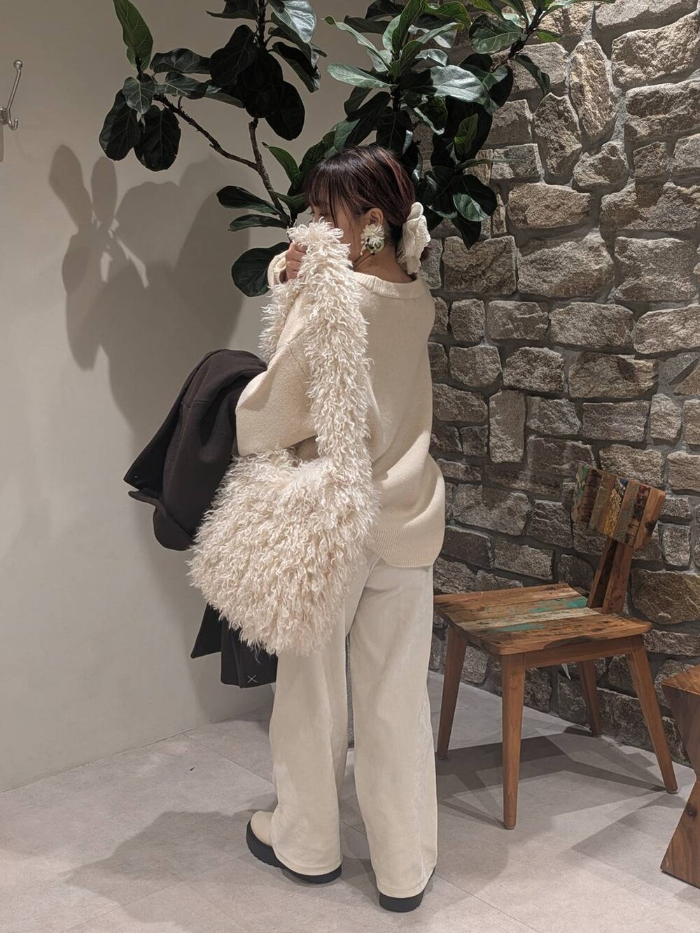 ブラウン系のチェスターコート、ベージュ系のブーツ、ベージュ系のショルダーバッグを着用したレディースの冬コーディネートの6枚目の写真