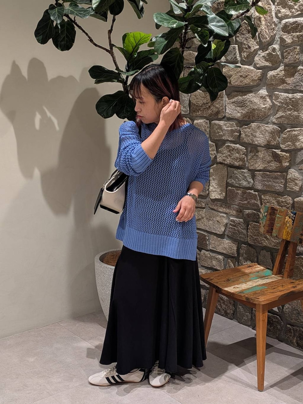 ブラック系のキャミソール、ホワイト系のスニーカー、ブラック系のハンドバッグを着用したレディースの春コーディネートの2枚目の写真