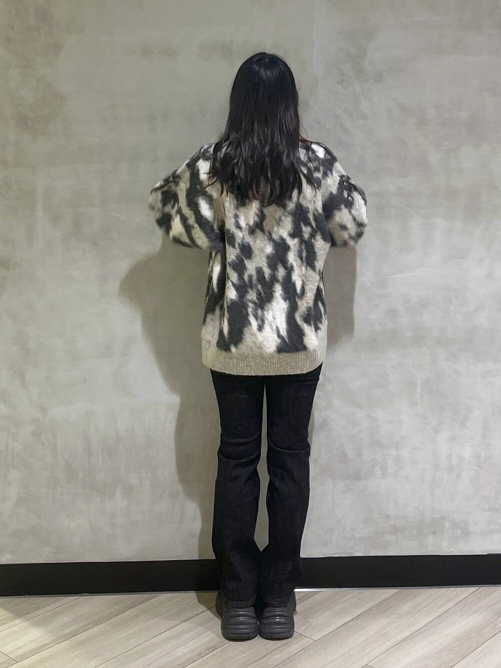 ブラック系のスニーカー、グレー系のニット/セーターを着用したレディースの秋コーディネートの5枚目の写真