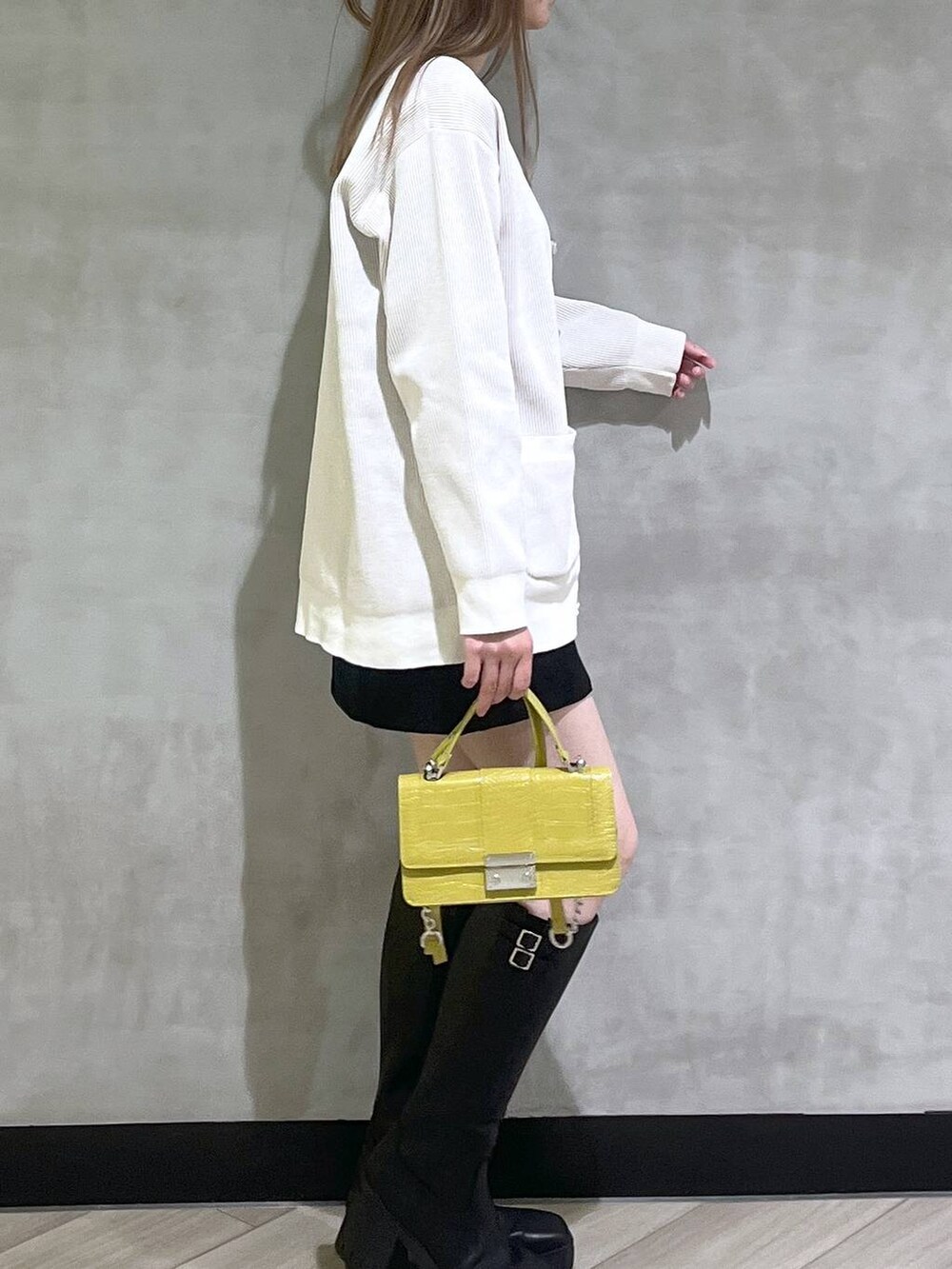 ブラック系のブーツ、ブラック系のスカート、ホワイト系のカーディガン/ボレロを着用したレディースの秋コーディネートの8枚目の写真