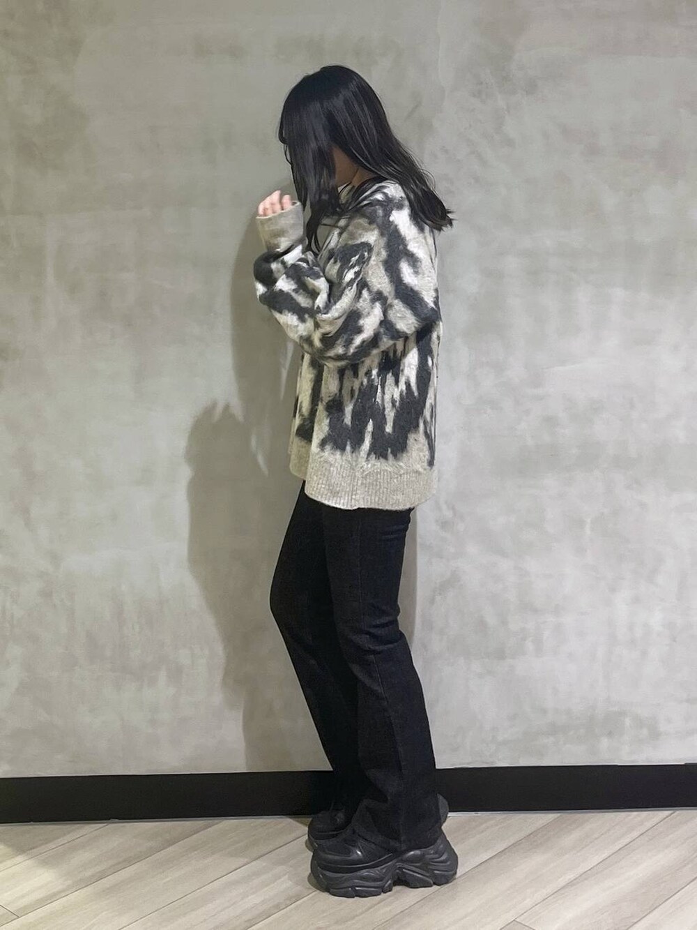 ブラック系のスニーカー、グレー系のニット/セーターを着用したレディースの秋コーディネートの3枚目の写真