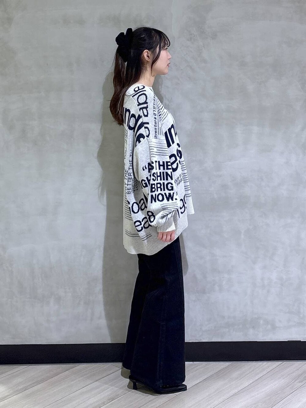 ブルー系のデニムパンツ、ブラック系のサンダル、グレー系のニット/セーターを着用したレディースの冬コーディネートの7枚目の写真