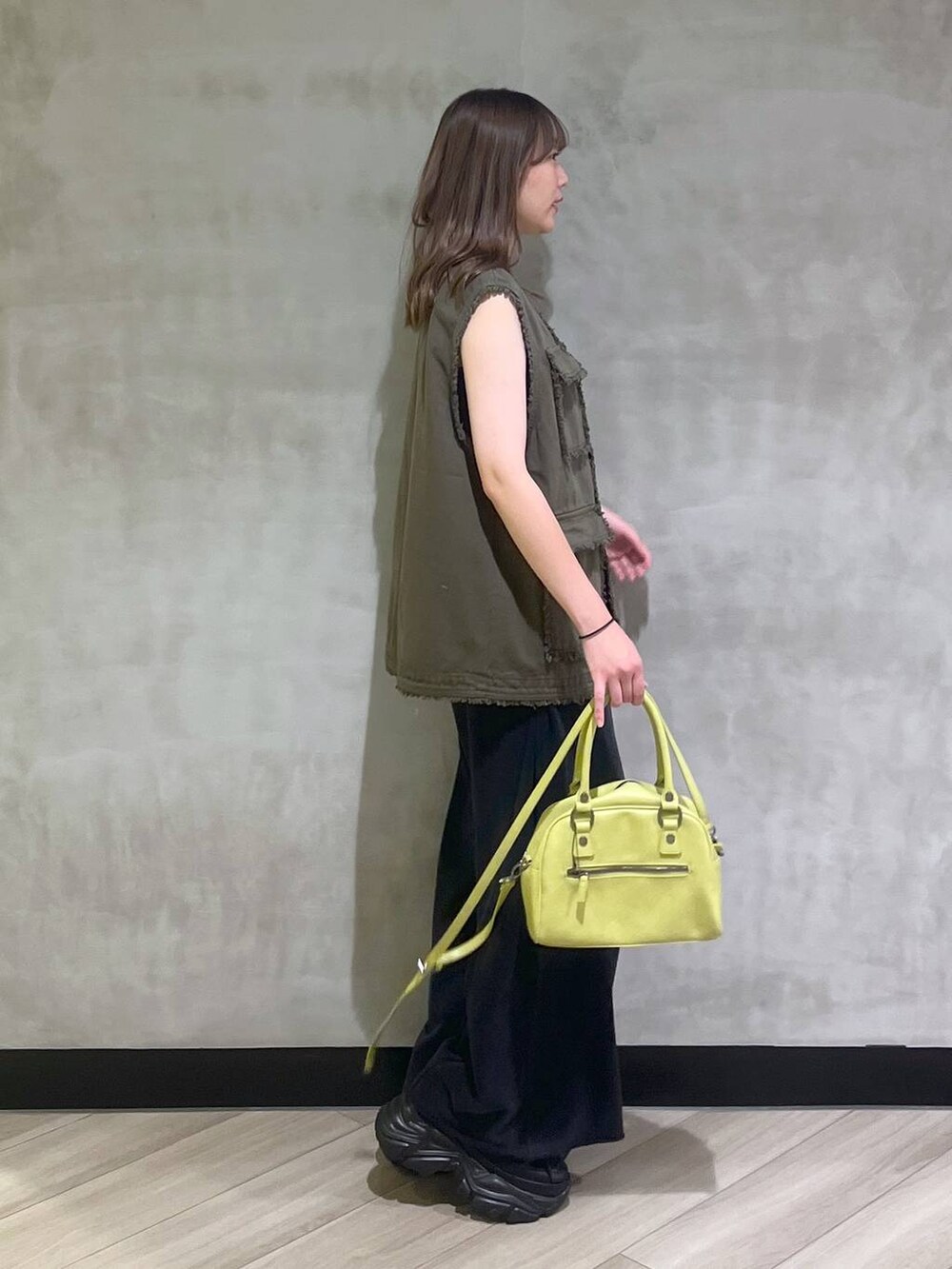 ブラック系のスニーカー、ブラック系のスウェットパンツ、グリーン系のその他アウターを着用したレディースの夏コーディネートの7枚目の写真