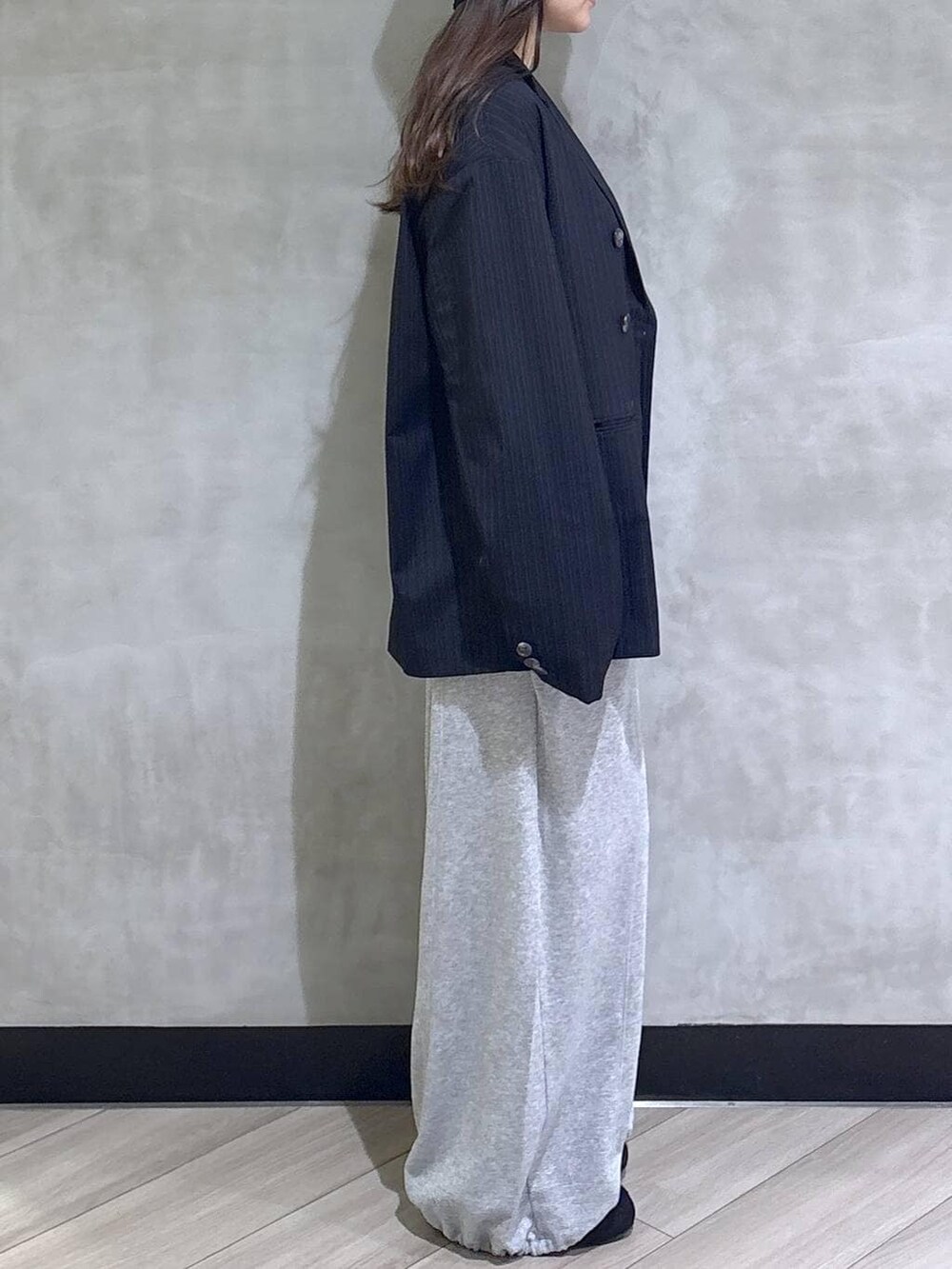 グレー系のスウェットパンツ、ブラック系のTシャツ/カットソー、ブラック系のモカシン/デッキシューズを着用したレディースの春コーディネートの6枚目の写真