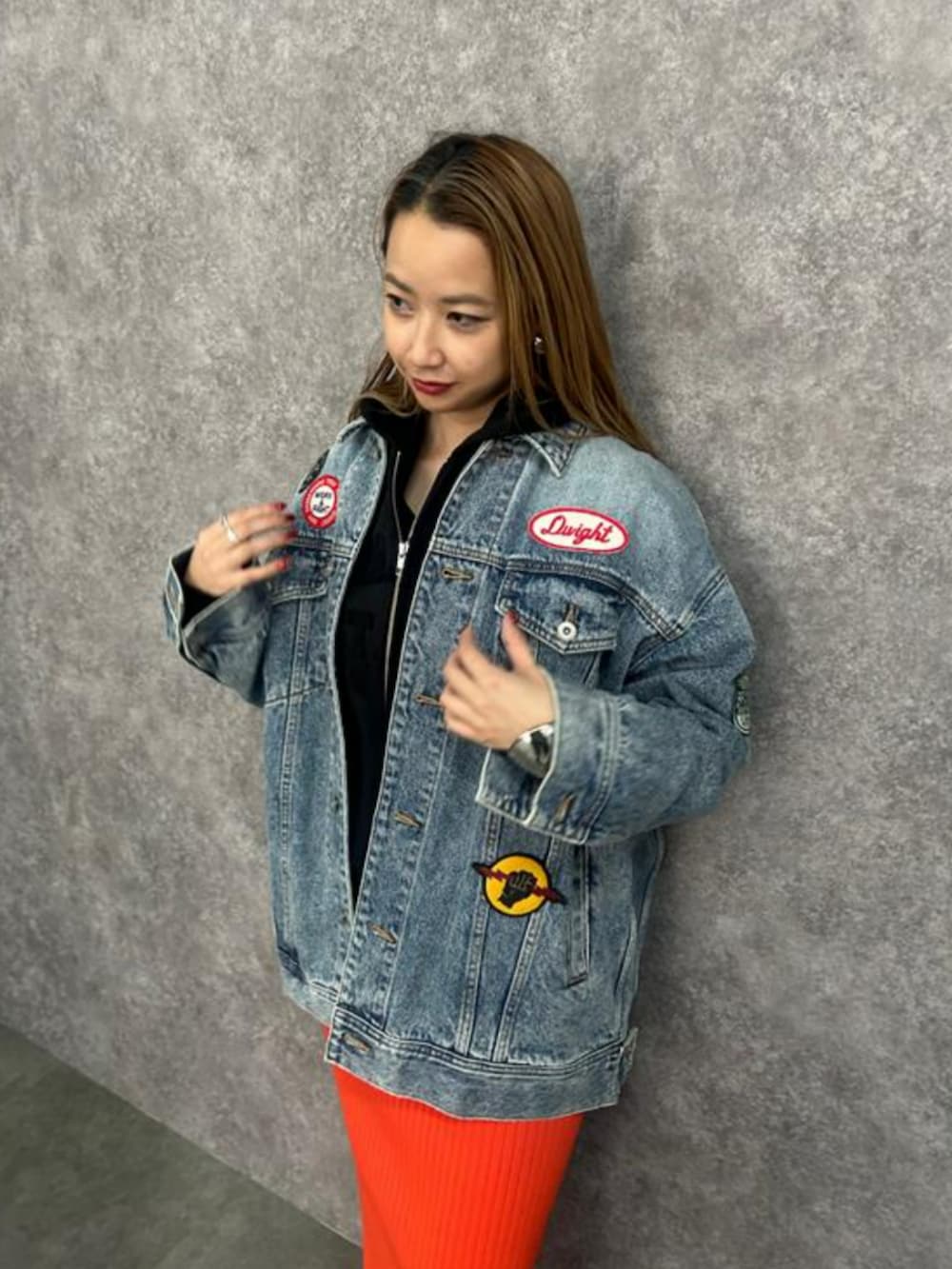 ブルー系のデニムジャケット、オレンジ系のスカートを着用したレディースの春コーディネートの4枚目の写真