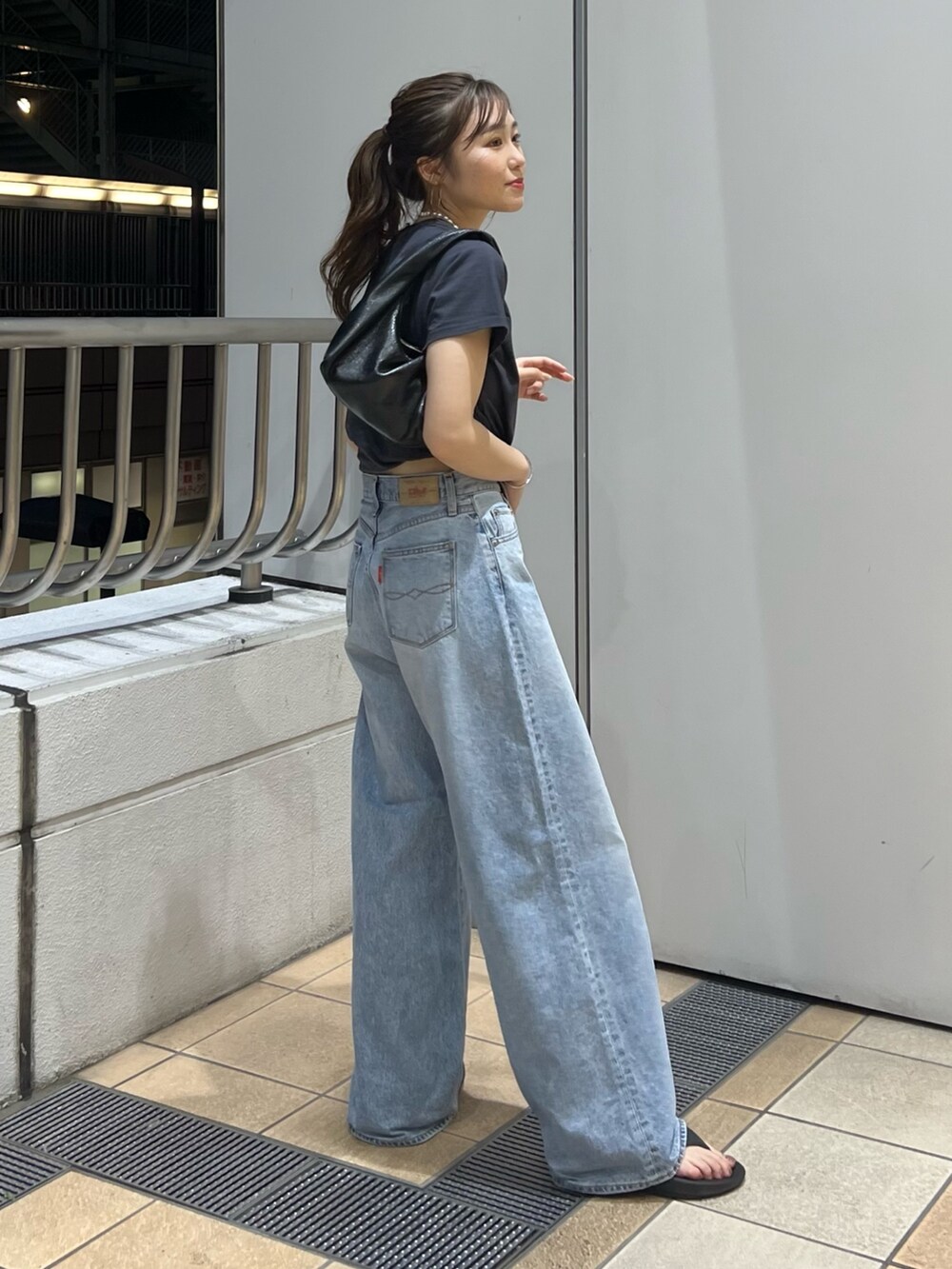 ブルー系のデニムパンツ、グレー系のTシャツ/カットソーを着用したレディースの夏コーディネートの3枚目の写真