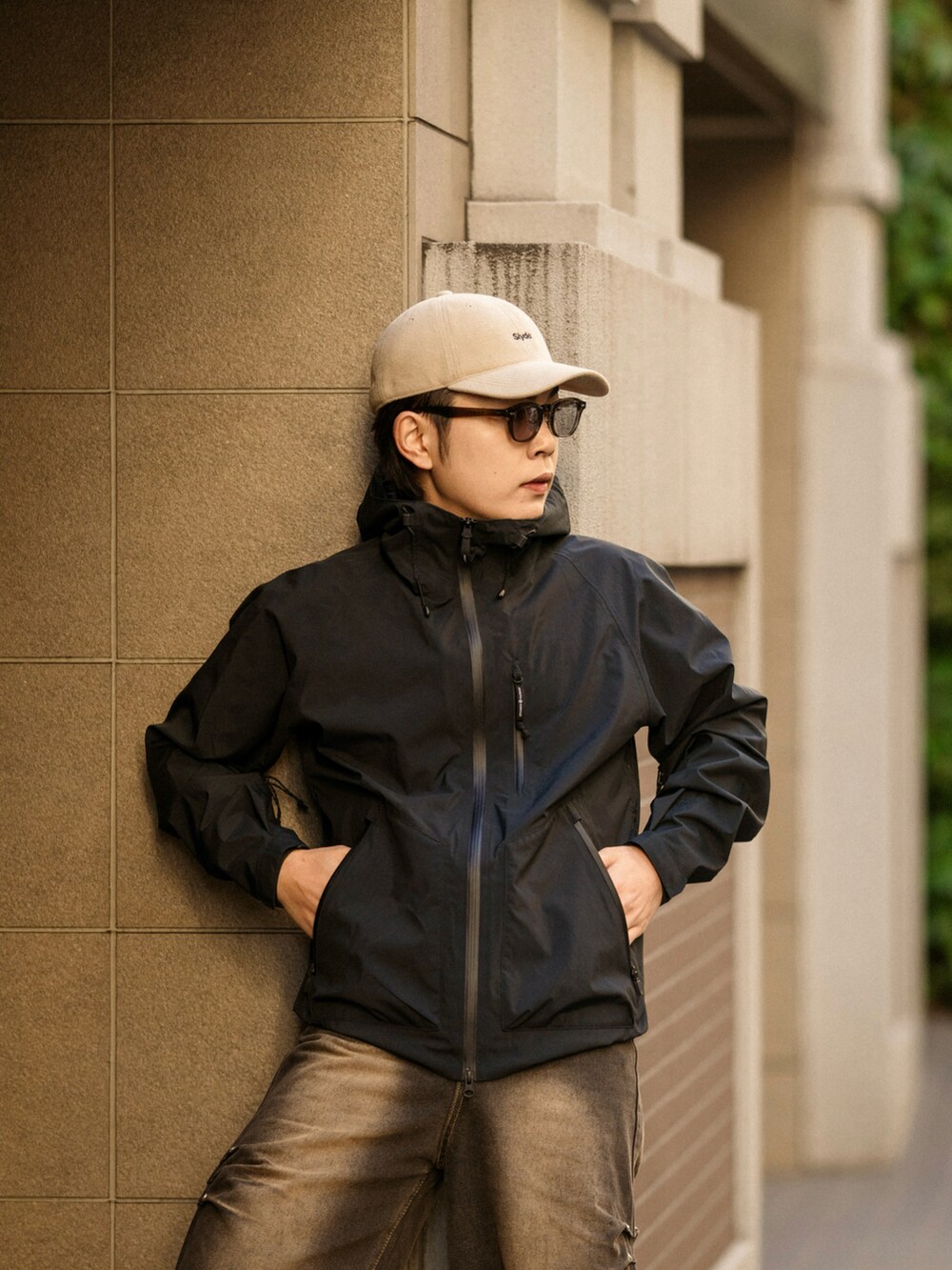ブラック系のデニムパンツ、ホワイト系のスニーカー、ベージュ系のキャップを着用したメンズの冬コーディネートの3枚目の写真