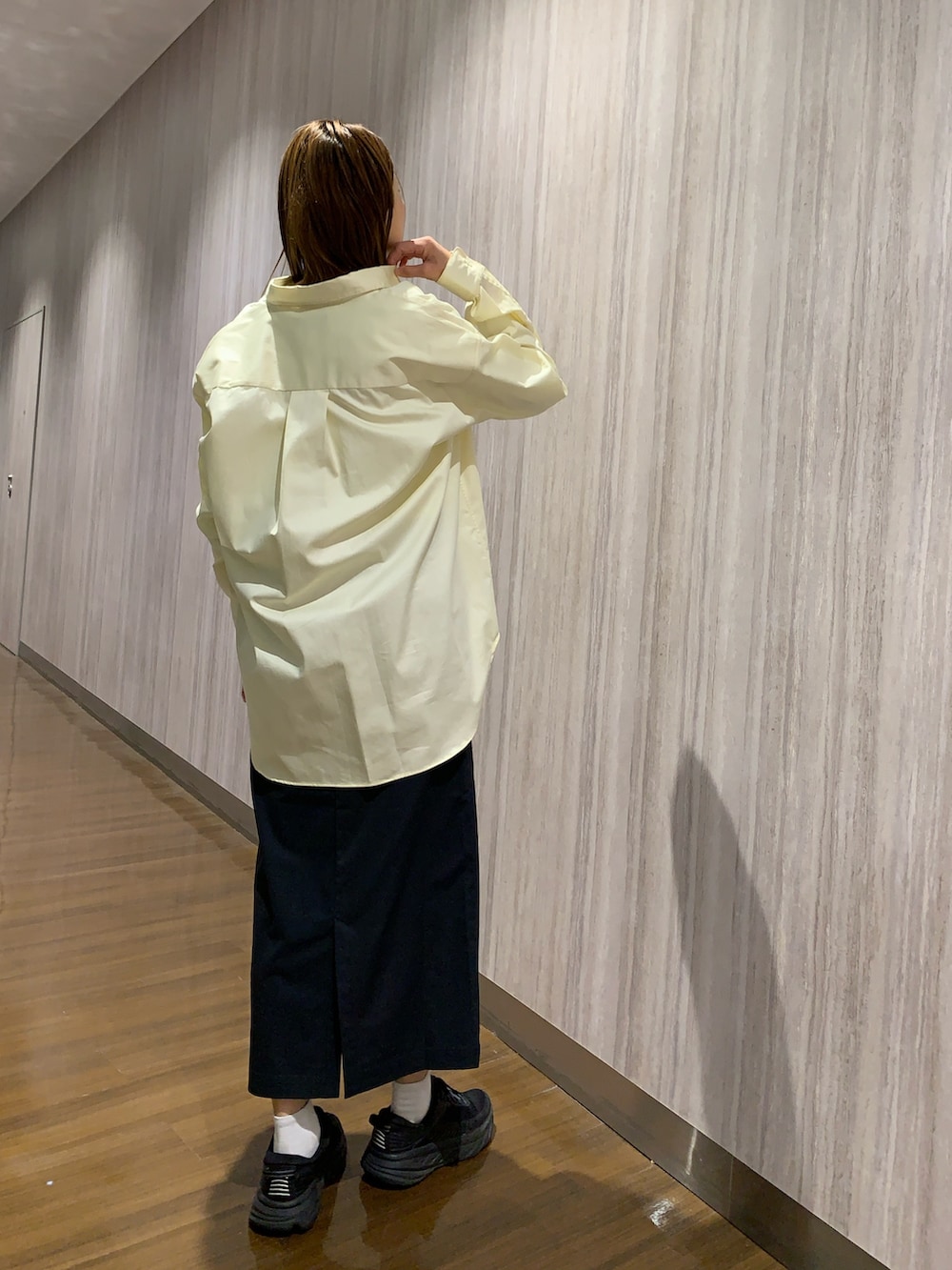 イエロー系のシャツ/ブラウス、ブルー系のスカートを着用したレディースの冬コーディネートの3枚目の写真