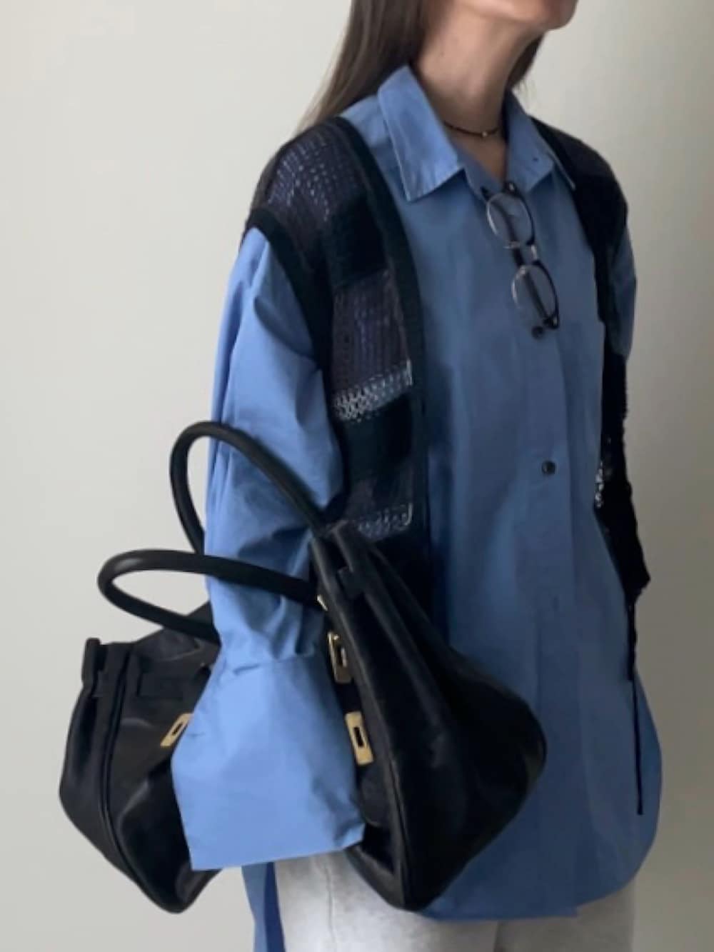 グレー系のベスト、グレー系のスウェットパンツ、ブラック系のトートバッグを着用したレディースの秋コーディネートの2枚目の写真