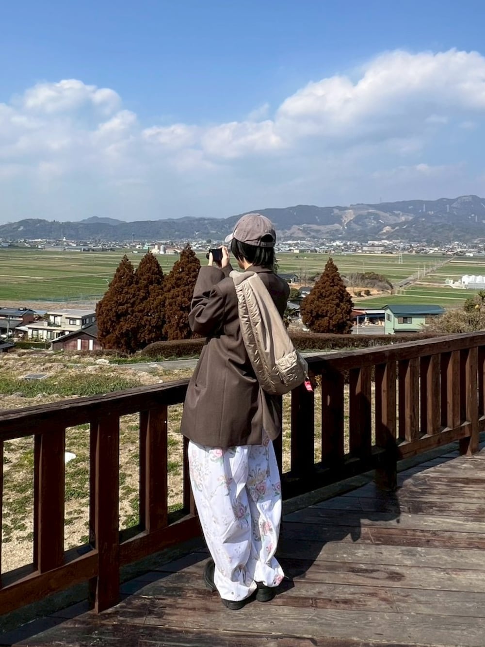 ブラック系のブーツ、ブラウン系のテーラードジャケット、グレー系のキャップを着用したレディースの冬コーディネートの3枚目の写真