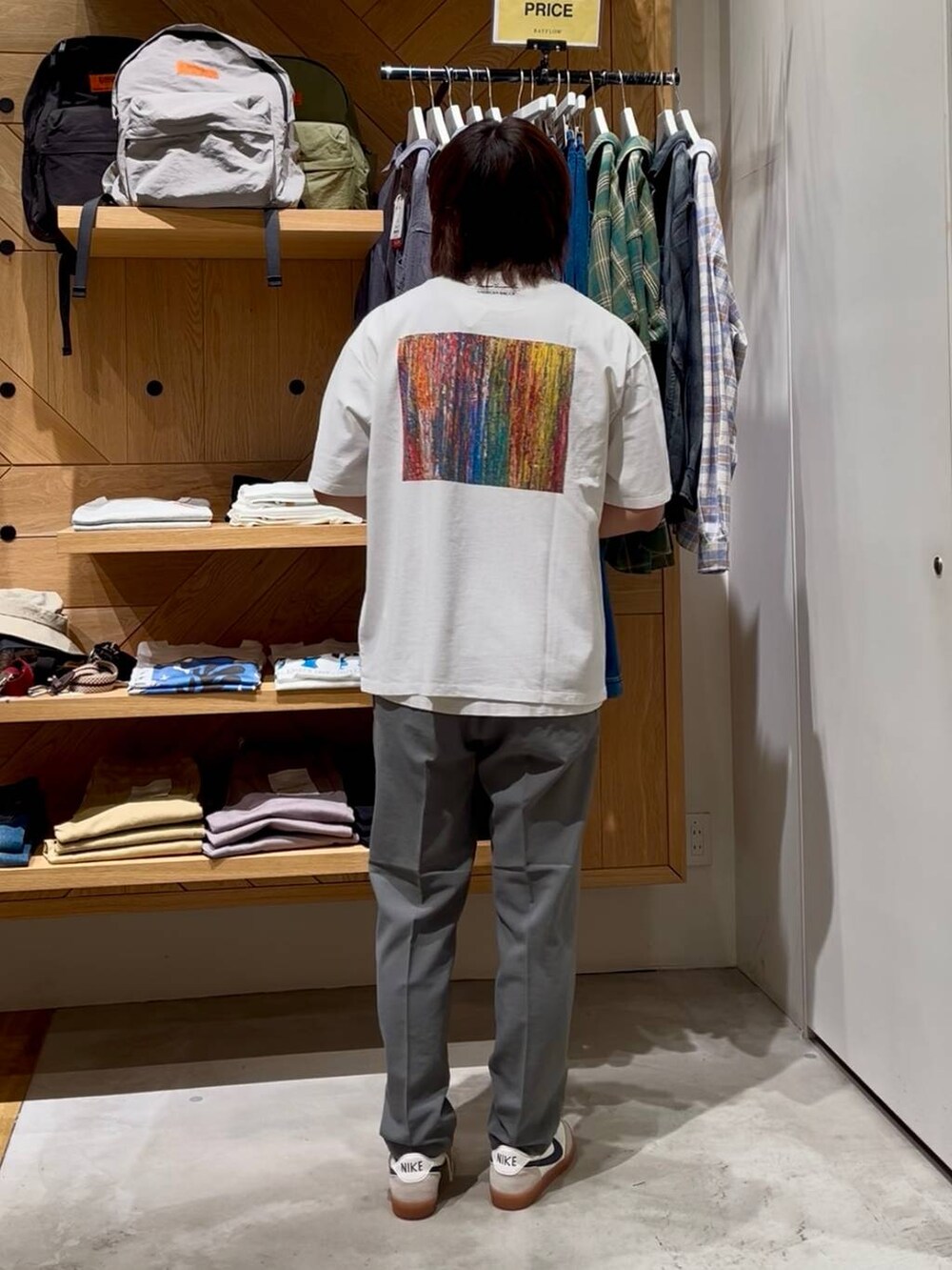 グレー系のスラックス、ホワイト系のタンクトップ、ホワイト系のTシャツ/カットソーを着用したメンズの春コーディネートの3枚目の写真