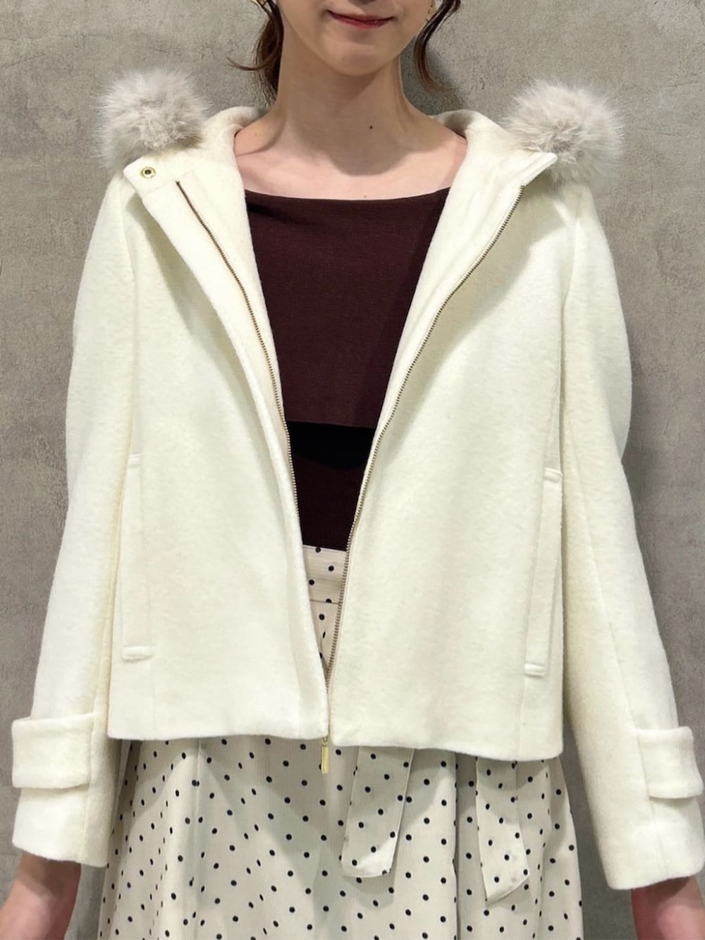 ホワイト系のワンピース、ホワイト系のブルゾン、ホワイト系のショルダーバッグを着用したレディースの秋コーディネートの3枚目の写真