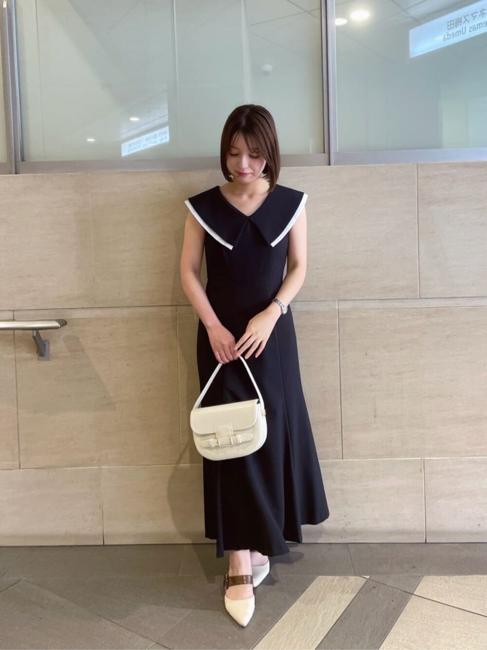 ブラック系のワンピースを着用したレディースの夏コーディネートの2枚目の写真