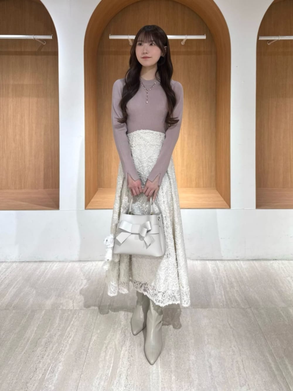 ピンク系のワンピースを着用したレディースの冬コーディネートの2枚目の写真