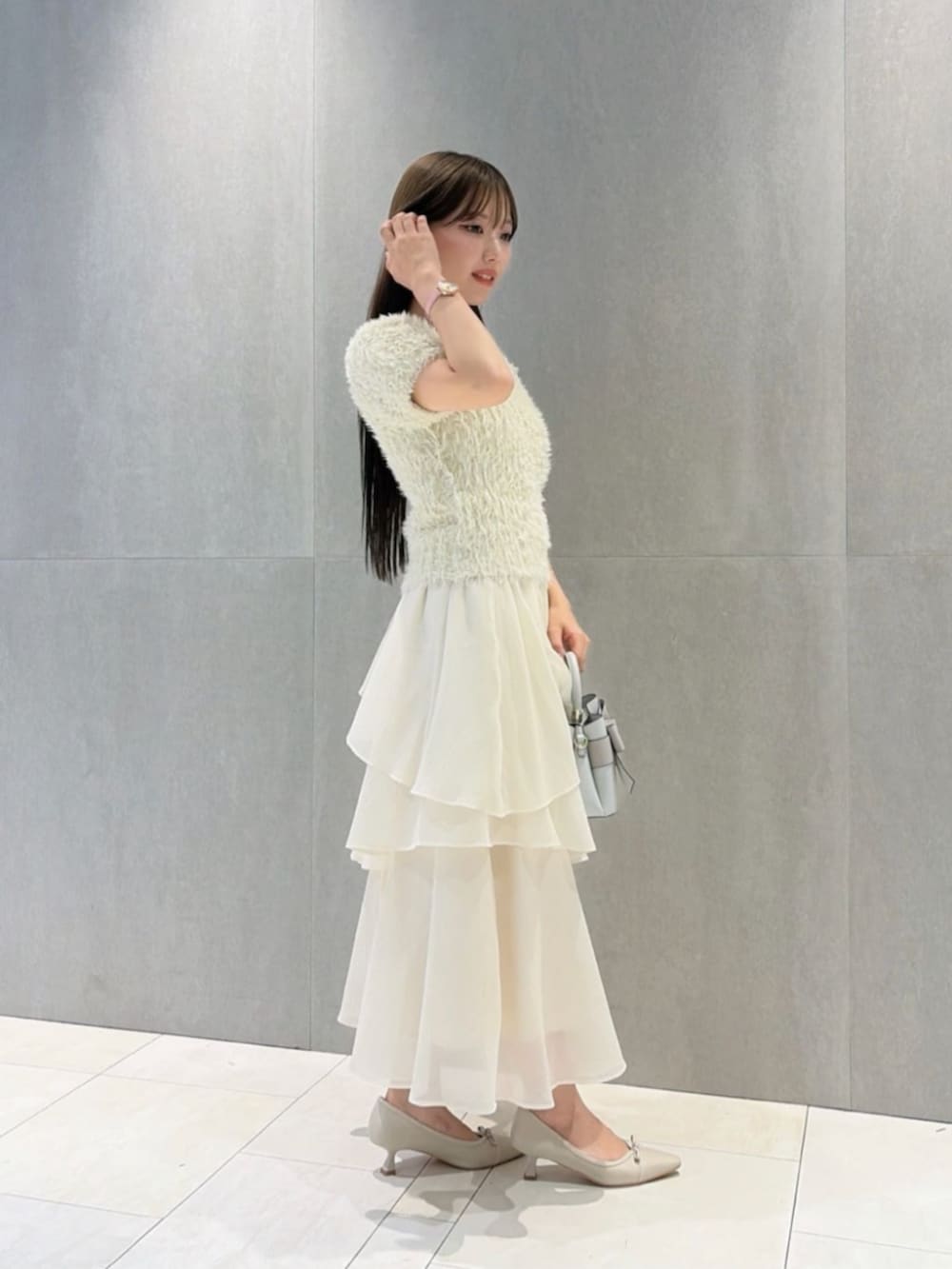 ベージュ系のパンプス、ホワイト系のニット/セーター、ホワイト系のスカートを着用したレディースの秋コーディネートの3枚目の写真