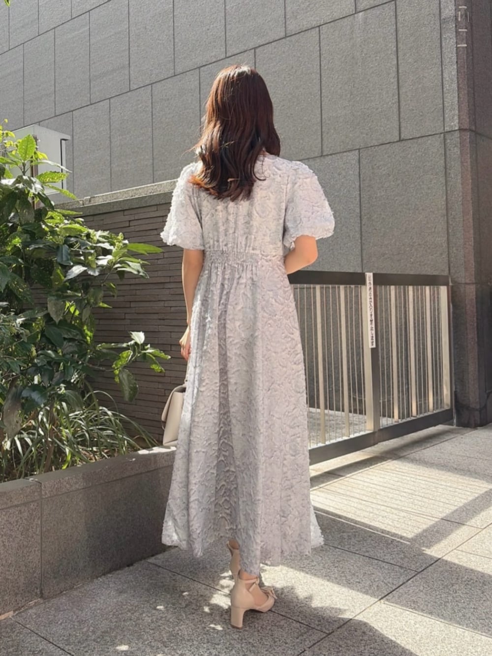 ベージュ系のパンプス、ブルー系のワンピースを着用したレディースの春コーディネートの3枚目の写真