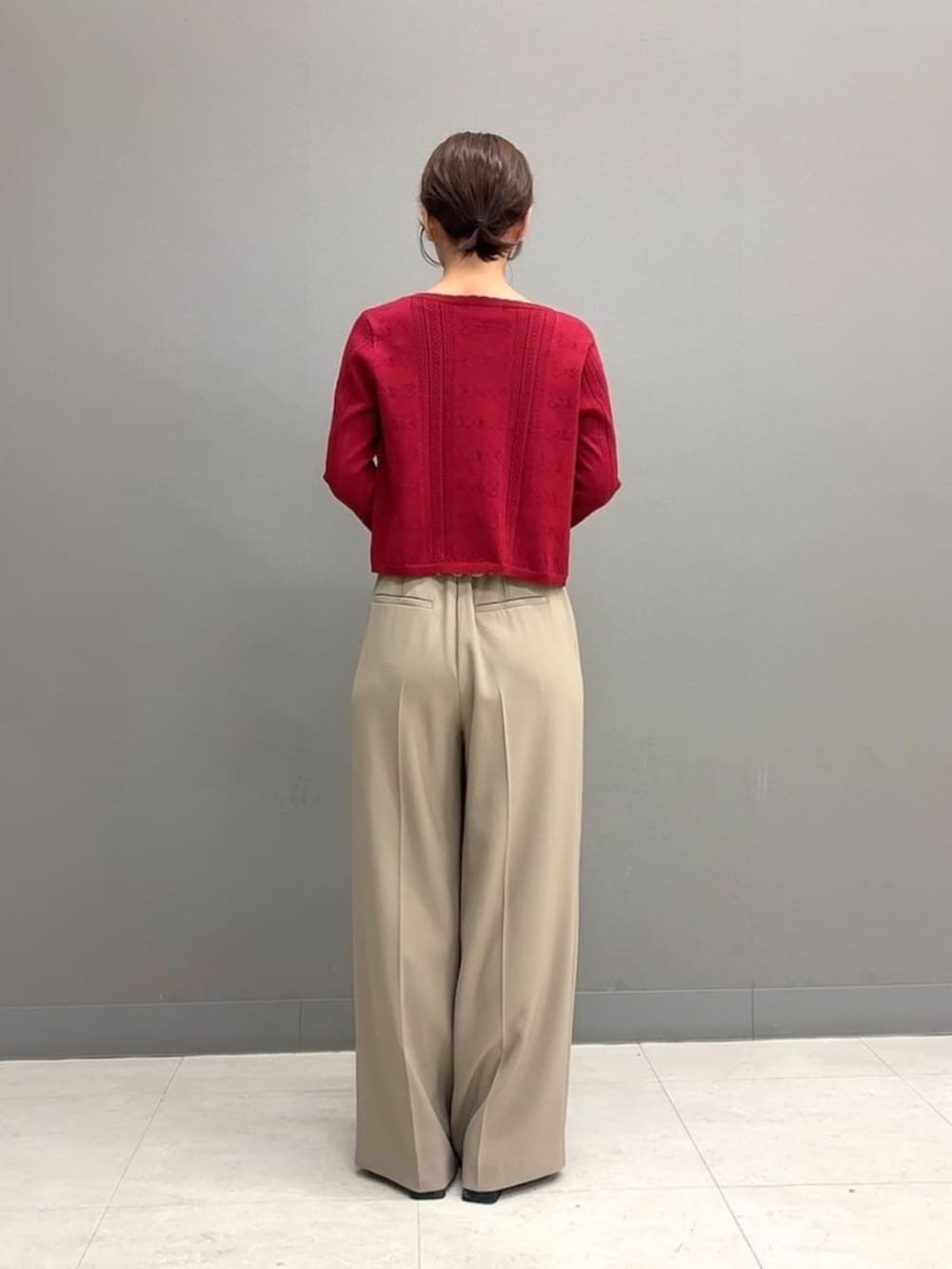 ホワイト系のショルダーバッグ、ベージュ系のその他パンツ、レッド系のアンサンブルを着用したレディースの秋コーディネートの4枚目の写真