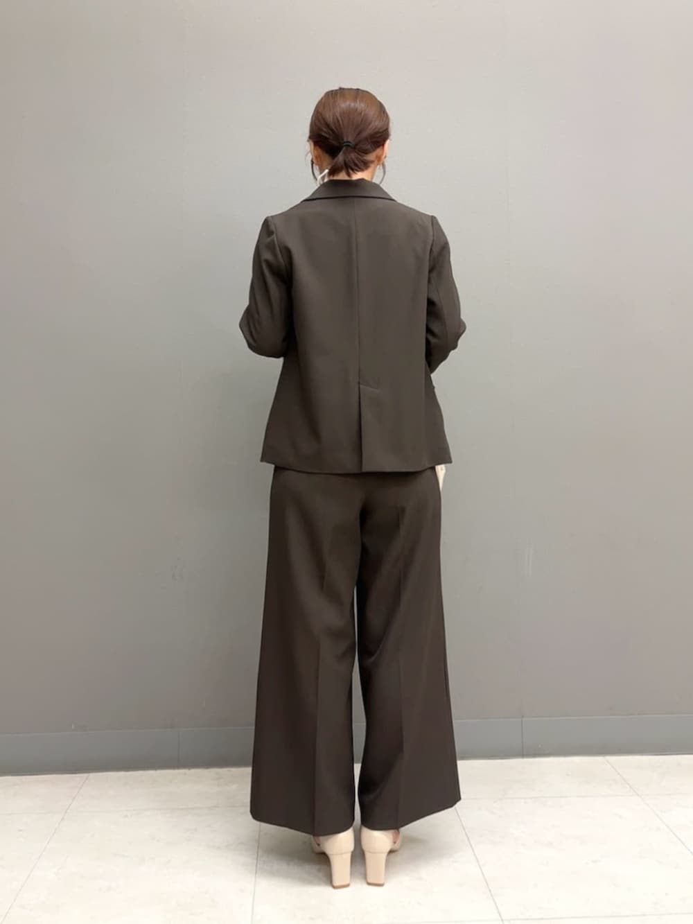 ベージュ系のパンプス、ホワイト系のボストンバッグ、ブラウン系のテーラードジャケットを着用したレディースの秋コーディネートの4枚目の写真