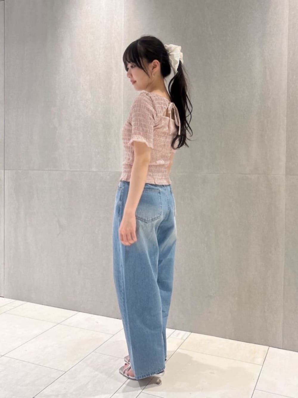 ホワイト系のショルダーバッグ、シルバー系のパンプス、ピンク系のTシャツ/カットソーを着用したレディースの春コーディネートの2枚目の写真