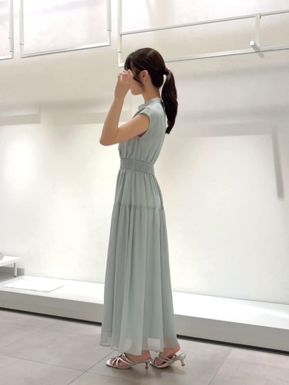 シルバー系のパンプス、ホワイト系のショルダーバッグ、ホワイト系のカーディガン/ボレロを着用したレディースの夏コーディネートの4枚目の写真