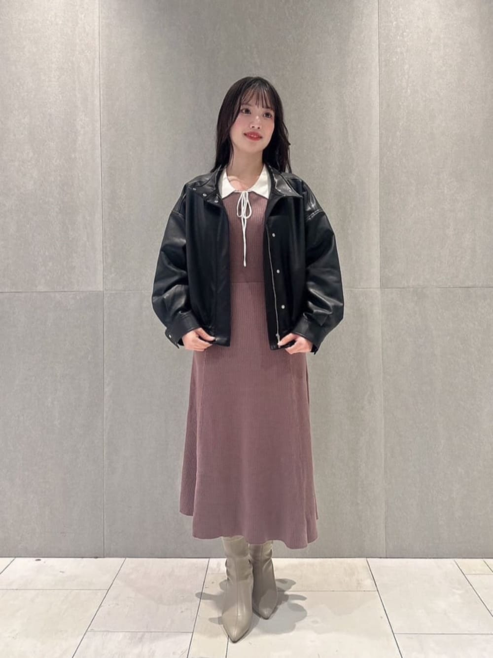 ブラック系のブルゾン、ブラウン系のワンピースを着用したレディースの冬コーディネートの2枚目の写真