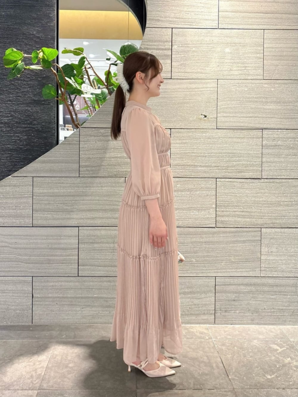 ピンク系のワンピースを着用したレディースの春コーディネートの2枚目の写真